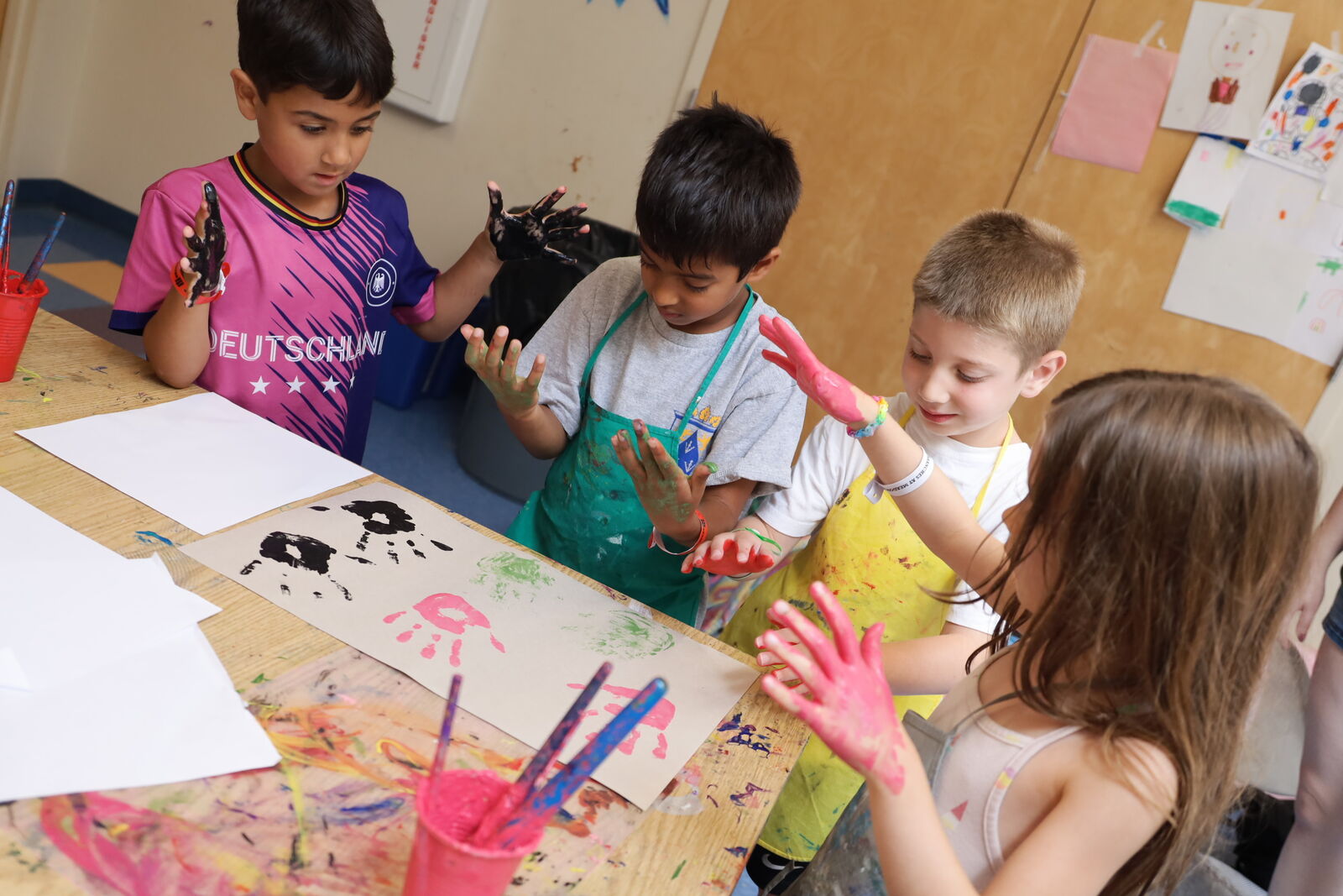 Campers creating artwork together at a shared table